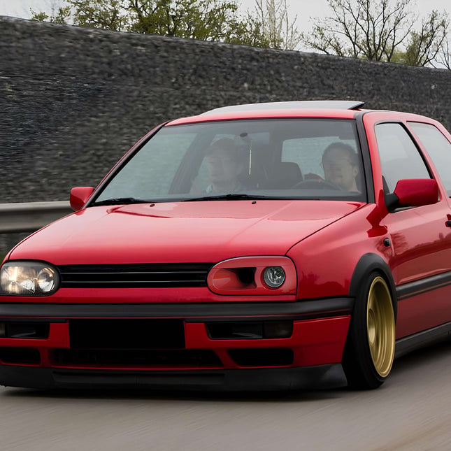 VW Golf MK3 1993-1998 Front Bumper Lip Spoiler – Enhance your Golf MK3 (95-98) with this aerodynamic front lip spoiler. Made from durable ABS plastic, it improves aerodynamics and adds a sleek, sporty look to your car while enhancing stability on the road.

