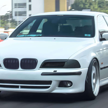 A lineup of BMW E39 5 Series sedans in various colors parked side by side, demonstrating the model's enduring popularity and the diverse range of trims and configurations available to buyers.

