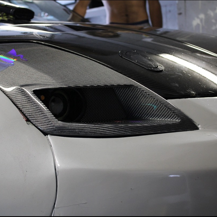Aftermarket Nissan 350Z carbon fiber mirror covers designed to replace OEM parts with lightweight, stylish alternatives. Improves the sporty appearance of your 350Z, adds a touch of luxury carbon fiber finish, and maintains durability for long-term use on the road.