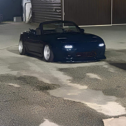 Miata MX-5 NA Roadster rear diffuser, carbon fiber underbody panel, improved airflow dynamics, reduced drag, high-performance track handling, lightweight construction, aggressive rear-end styling.

