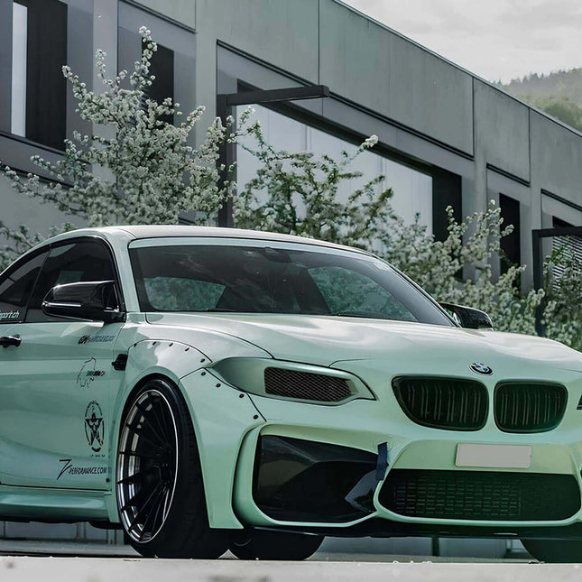 "Front three-quarter view of a 2 Series convertible (F23), featuring its open-top design and sleek headlights."