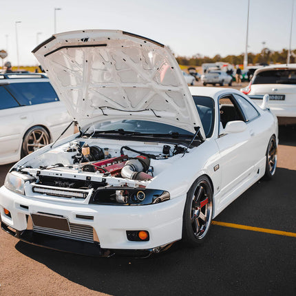 Skyline R33 GTR lightweight carbon fiber driveshaft, reduced rotational mass, improved acceleration, high-performance torque transfer, track-proven power delivery upgrade.

