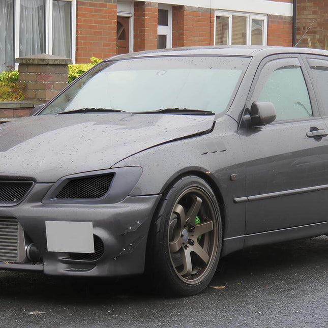 "Close-up of an RS300 Altezza's interior, showcasing its sports seats, aluminum pedals, and driver-focused dashboard."