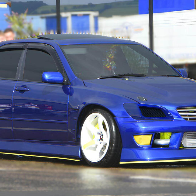 "A turbocharged RS200 Altezza featuring a custom front grille, carbon fiber hood, and wide tires for improved grip."