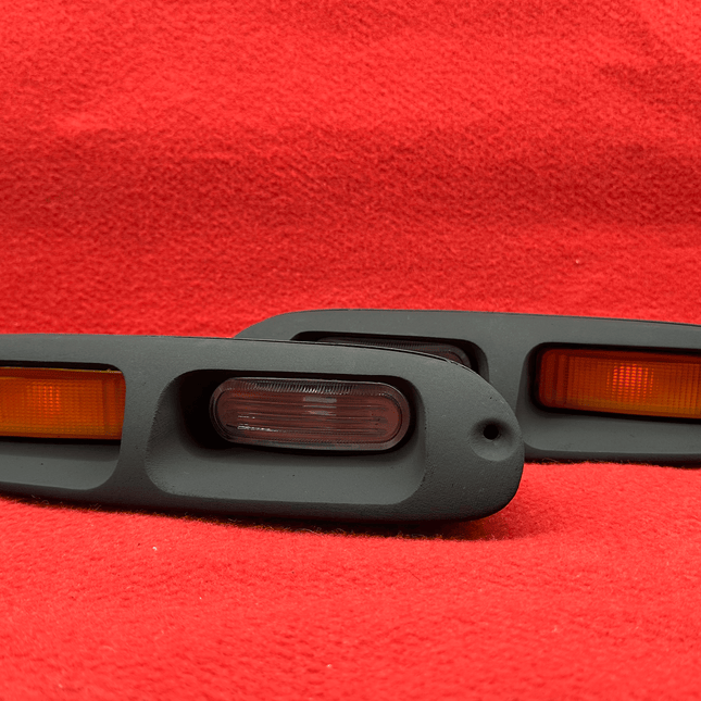 Miata MX-5 NA Roadster front bumper turn signal retrofit, high-intensity amber LED bulbs, clear lens housing, sequential indicator function, street-legal lighting, stylish JDM-inspired front-end upgrade.

