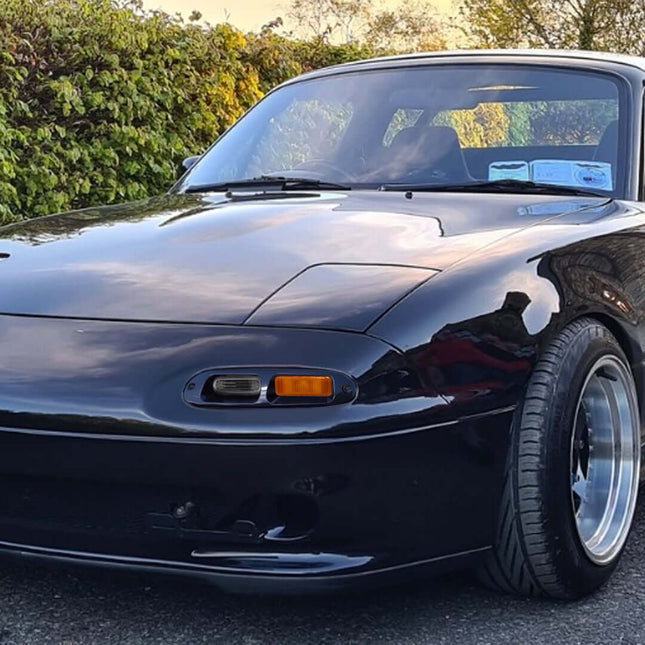 Miata MX-5 NA Roadster smoked turn signal kit, LED bumper indicators, high-powered amber flashers, sequential signal function, sleek modern lighting, plug-and-play installation, aggressive front-end aesthetic.

