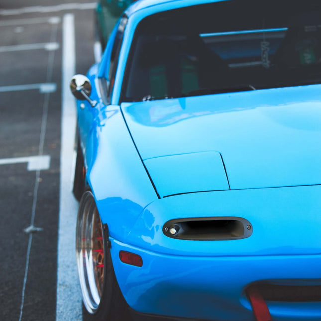 Mazda Miata MX-5 NA Roadster carbon fiber hood, lightweight vented race hood, improved engine cooling, heat dissipation, track-spec aerodynamics, high-performance weight reduction, aggressive styling.

