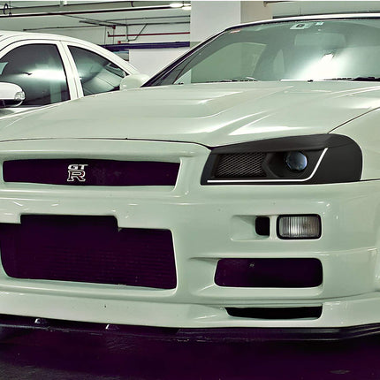 Nissan Skyline R34 GTS stainless steel turbo downpipe, improved exhaust flow, increased turbo efficiency, race-ready high-performance exhaust upgrade, aggressive power increase.

