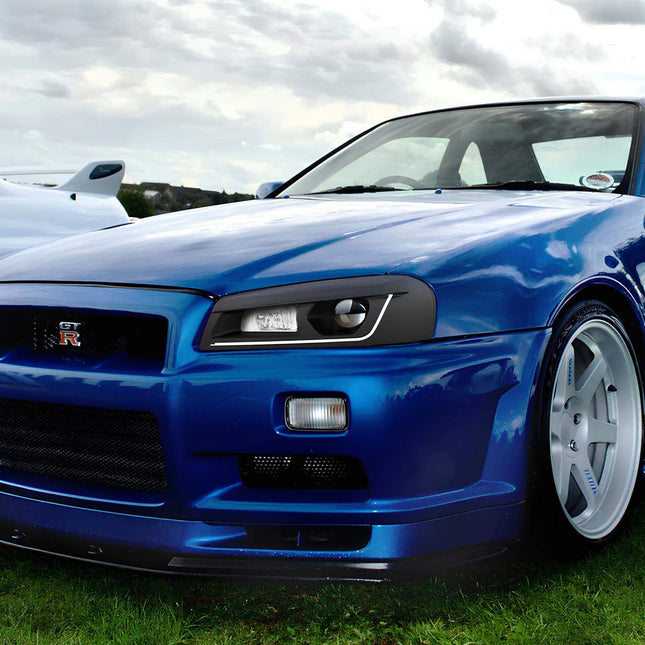 Skyline R34 GTS lightweight pulley kit, CNC-machined aluminum crank pulleys, reduced rotational mass, improved throttle response, high-RPM acceleration enhancement.

