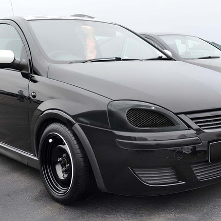 "A modified Corsa GSi with an aggressive front bumper, lightweight alloy wheels, and a lowered stance for enhanced handling."