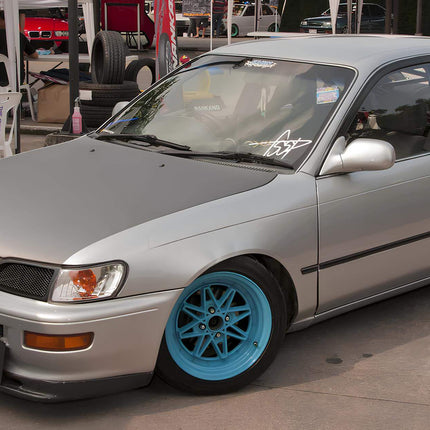 Toyota Corolla AE100 performance oil cooler, billet aluminum housing, stainless steel braided lines, reduced engine temperatures, track-proven thermal management system.

