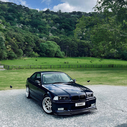 Carbon fiber front splitter for BMW E36 Coupe, Sedan & Cabriolet, designed for improved aerodynamics, increased downforce, and aggressive styling. Enhances high-speed stability while maintaining OEM fitment.

