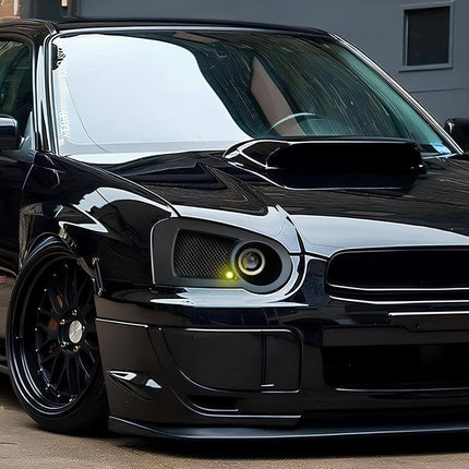 Close-up of the 2004 Subaru Impreza WRX's 2.0-liter turbocharged boxer engine, showcasing the top-mounted intercooler and red intake manifold, highlighting Subaru's engineering focus on balance and power delivery.

