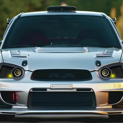 Rear three-quarter view of a 2003 Subaru Impreza RS Sedan in Platinum Silver Metallic, displaying the subtle rear spoiler and clean body lines, representing the entry-level model's blend of practicality and sporty aesthetics.

