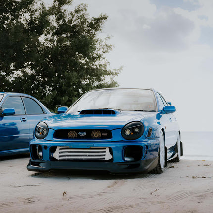 2002-2003 WRX carbon fiber driveshaft, reduced rotational mass, improved throttle response, optimized torque transfer, track-proven drivetrain upgrade.

