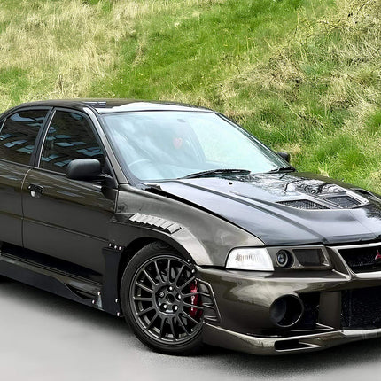 Mitsubishi Evolution V, VI turbo upgrade kit, high-boost ball-bearing turbocharger, external wastegate, front-mount intercooler, high-flow turbo manifold, race-tuned ECU, dyno-proven horsepower gains, track-ready forced induction system.

