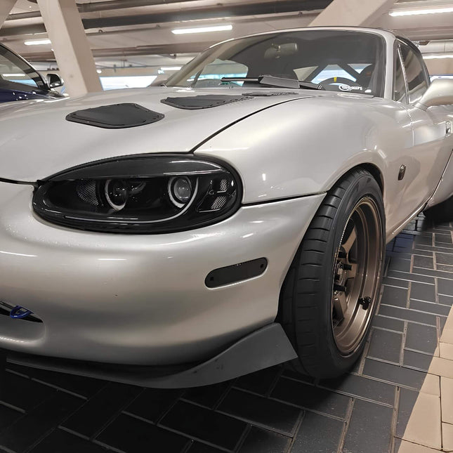 Miata MX-5 NB1 upgraded fuel delivery system, high-flow fuel pump, larger injectors, adjustable fuel pressure regulator, E85 compatibility, race-ready fuel system, dyno-tuned air-fuel ratio optimization, forced induction setup.

