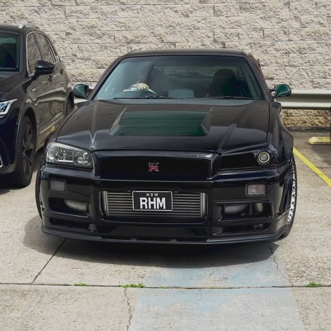 Nissan Skyline R34 GTR twin-turbo kit, high-boost ball-bearing turbos, stainless steel turbo manifold, external wastegate, race-tuned ECU, track-ready forced induction system, dyno-tested horsepower gains, aggressive throttle response.


